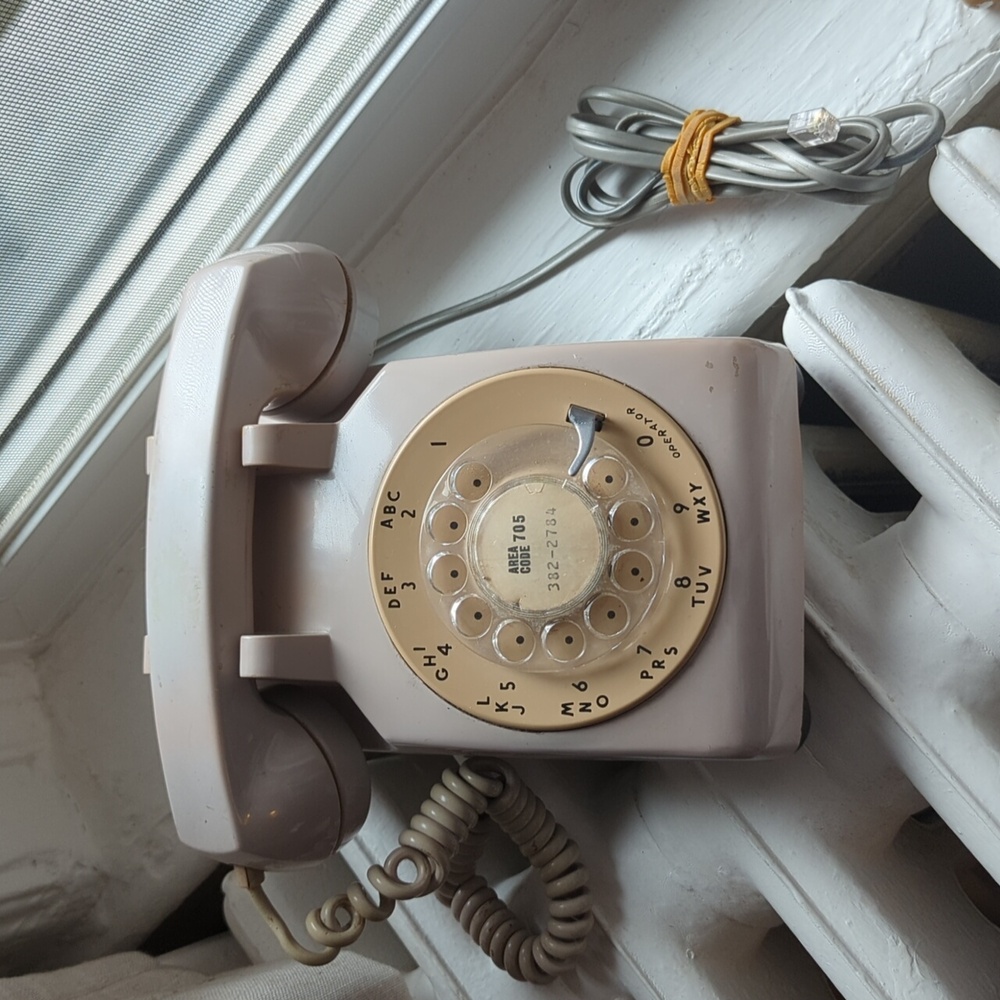 Vintage rotary phone in warm beige